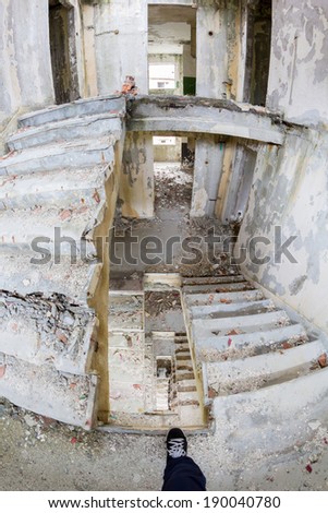 Interior stairs from abandoned block of flats under construction. Brick and cement textures