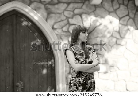 Black and white photo of a beautiful, caucasian, young, long haired woman posing in urban locations with natural background