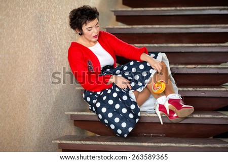 Photo session of an expressive,short haired brunette woman with lollipop