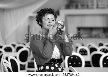 Photo session of an expressive,short haired brunette woman during making up session. Black and white photography