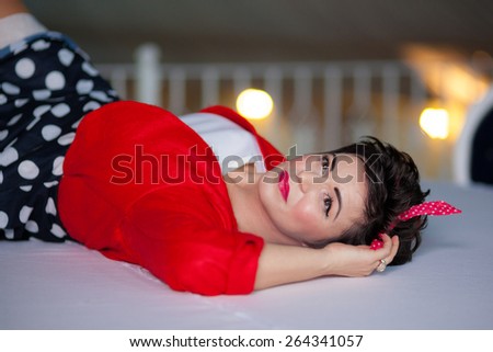 Photo session of an expressive,short haired, brunette woman sitting on the floor