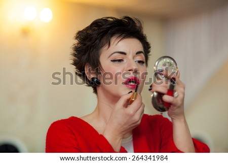 Photo session of an expressive,short haired, brunette woman during the make up session