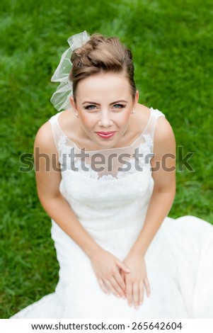 Beautiful, caucasian, long haired woman wearing a wedding dress with natural background
