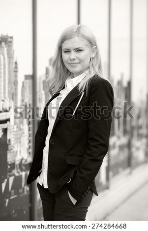 Blonde, expressive business woman looking pleased. Black and white photography