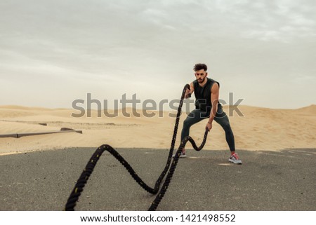 Similar – Image, Stock Photo Sportsman jogging on sandy terrain in mountainous terrain