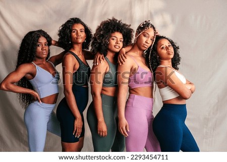 Similar – Image, Stock Photo Confident African American woman in stylish outfit at entrance of contemporary building with orange tiled facade