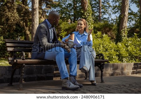 Similar – Image, Stock Photo Elegant black man talking smartphone leaning building