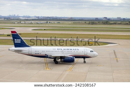 Dallas, Texas, USA - September 18, 2014: US Airways airline passenger jet on the tarmac in Dallas - Ft Worth Airport with Dallas, Texas in the background on September 18, 2014