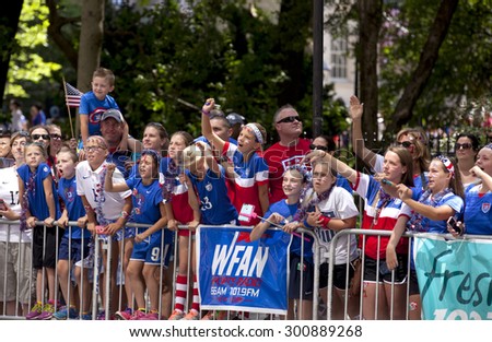 New York City, New York, USA - July 10, 2015: USA women's soccer team fans cheer  during the ticker tape parade to celebrate the team FIFA World Cup victory in New York City, NY on July 10, 2015
