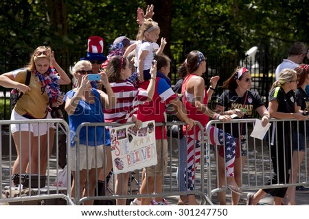 New York City, New York, USA - July 10, 2015: USA women\'s soccer team fans cheer  during the ticker tape parade to celebrate the team FIFA World Cup victory in New York City, NY on July 10, 2015