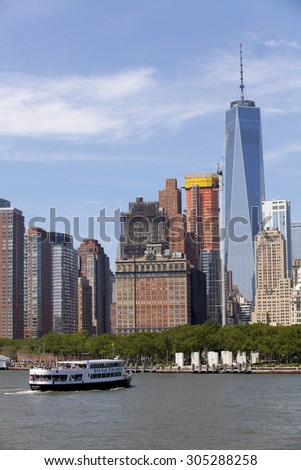 New York City, New York, USA - July 10, 2015: Statue Cruise Ferries returning to Manhattan from the Statue of Liberty full of tourist in New York Harbor, New York City, New York, on July 10, 2015.