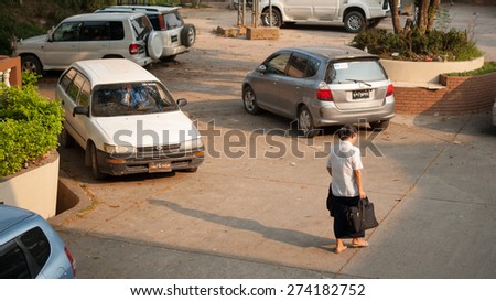 TACHILEIK, MYANMAR - APR 13: Unidentified woman walk to her car after finish her work on Apr 13,2014 in Tachileik Border Market, Tachileik, Myanmar.