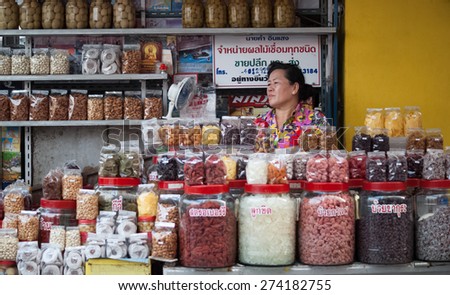 CHIANG RAI, THAILAND - APR 13: Unidentified woman sells nuts and dried fruits in the market on Apr 13,2014 in Mae Sai Border Market, Chiang Rai, Thailand.