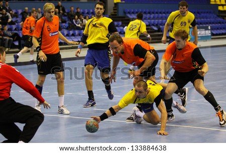 KYIV, UKRAINE - APRIL 2: Netherlands handball players (in orange) defend their net during EHF EURO 2014 qualification game against Ukraine on April 2, 2013 in Kyiv, Ukraine