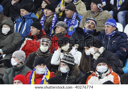KIEV, UKRAINE - NOVEMBER 4: Dynamo Kiev fans wear protective masks and fill up the stadium during an UEFA CL match despite fears of the spread of the A/H1N1 virus on Nov 4, 2009 in Kiev