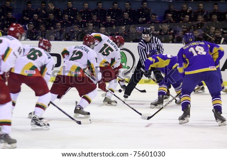 KYIV, UKRAINE - APRIL 18: Referee face-off the rink during IIHF Ice-hockey World Championship DIV I Group B game between Ukraine (in Blue) and Lithuania on April 18, 2011 in Kyiv, Ukraine