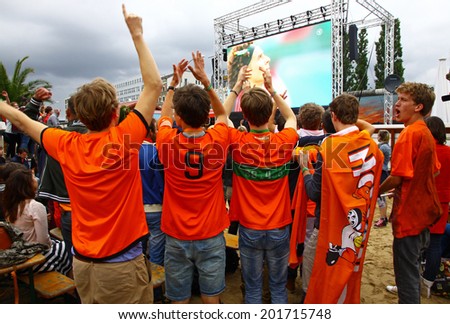 BERLIN, GERMANY - JUNE 29, 2014: Netherlands football team fans support their team at fan-zone during 2014 FIFA World Cup Brazil game against Mexico