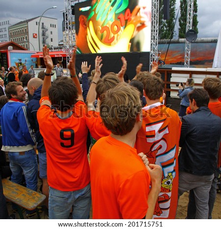 BERLIN, GERMANY - JUNE 29, 2014: Netherlands football team fans support their team at fan-zone during 2014 FIFA World Cup Brazil game against Mexico