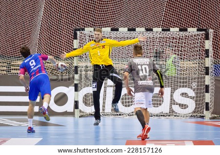 KYIV, UKRAINE - OCTOBER 18, 2014: Oleg Skopintsev of Motor (#9) throws the penalty kick during European Handball Champions League game against Aalborg