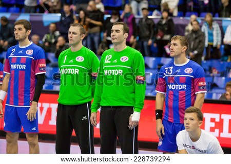 KYIV, UKRAINE - OCTOBER 18, 2014: Handball players of team Motor listen the anthem before European Handball Champions League game against Aalborg
