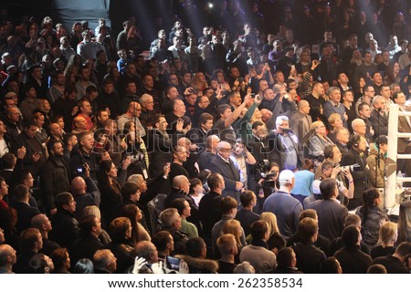 KYIV, UKRAINE - DECEMBER 13, 2014: People sing the National Anthem of Ukraine before WBO Intercontinental Cruiserweight Title fight between Oleksandr Usyk (Ukraine) and Danie Venter (South Africa)