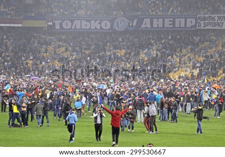 KYIV, UKRAINE - MAY 14, 2015: FC Dnipro supporters run out into the pitch to celebrate victory after UEFA Europa League semifinal game against Napoli at NSK Olimpiyskyi stadium