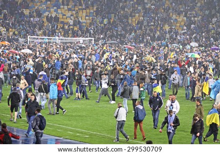 KYIV, UKRAINE - MAY 14, 2015: FC Dnipro supporters run out into the pitch to celebrate the winning after UEFA Europa League semifinal game against Napoli at NSK Olimpiyskyi stadium