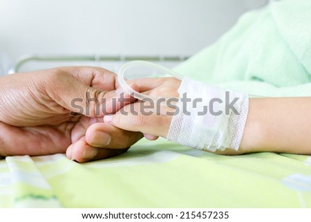 IV solution in a child\'s patients hand