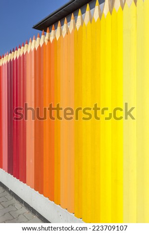 Kindergarten fence with colored pencils