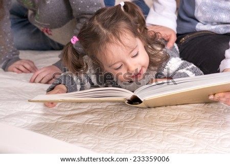 Little girl holding a big book