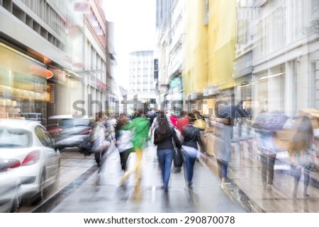 Intentional blurred image of people in city, zoom effect
