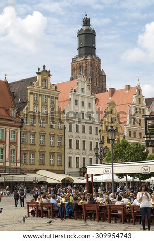 Wroclaw, Poland, 23 May 2015: People eating lunch at a street restaurant in old town of Wroclaw, Poland