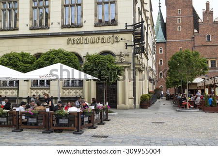 Wroclaw, Poland, 23 May 2015: People eating lunch at a street restaurant in old town of Wroclaw, Poland