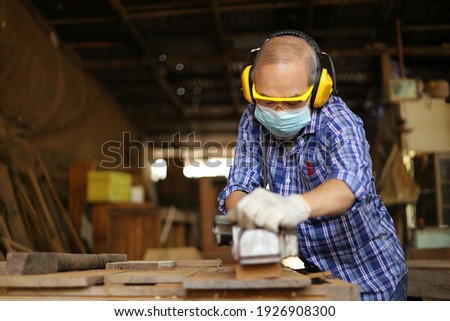 Similar – Image, Stock Photo Skilled woodworker using milling machine while working with lumber in contemporary workroom
