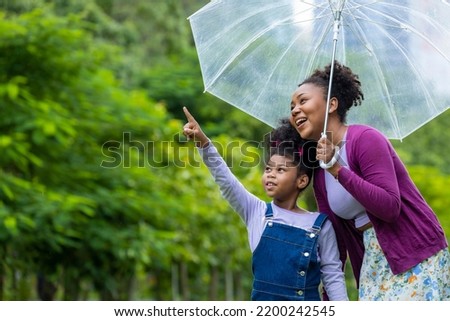 Similar – Foto Bild Kind mit grünem Regenschirm