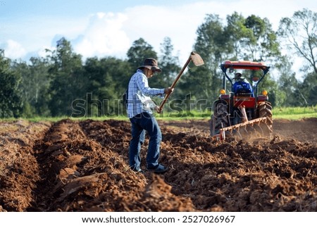 Similar – Image, Stock Photo Potato plantation and tractor farmer cultivating rows. Agroindustry and agribusiness. Cultivation of a young potato field. Loosening of the soil between the rows of bushes. Blurry