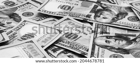 Cash hundred dollar bills, dollar background image. Scattered dollars. A big pile of dollars. Background of North American dollar bills. Black and white style.