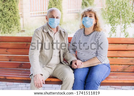 Similar – Image, Stock Photo Senior couple wearing protective face masks outdoors