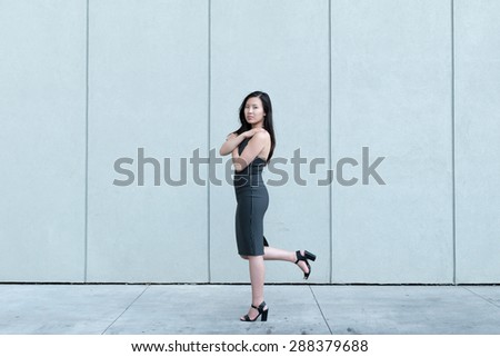 Asian model in black strip dress