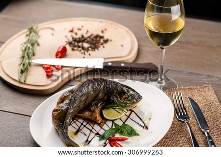 Fried fish with glass of wine