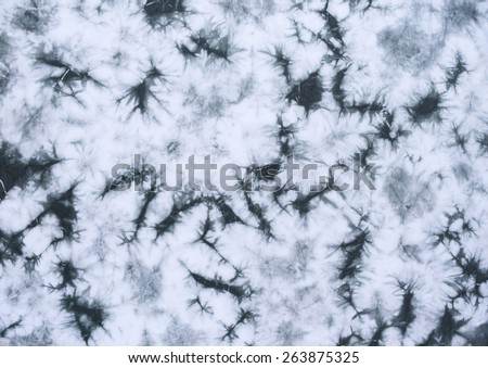 grey tie dyed pattern on cotton fabric as background.