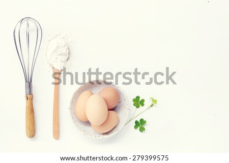 eggs and flour on white table background. basic baking background.