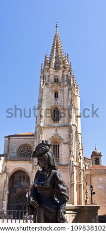 Cathedral of Oviedo with a bronze statue of a woman in the foreground