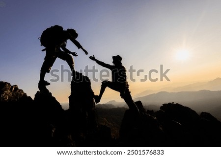 Similar – Image, Stock Photo Two mountaineers climb a summit with a summit cross in heavy snowfall. There is no room at the summit cross.