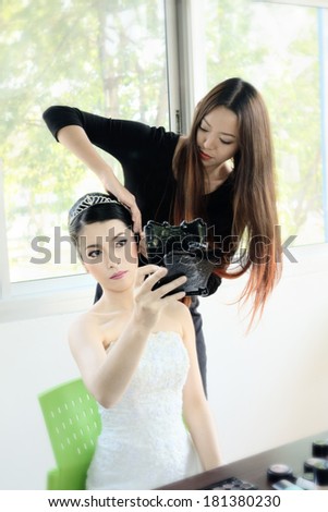 Asia girl  applying makeup by makeup artist/Wedding makeup artist
