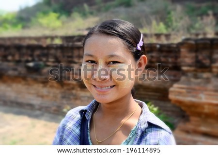 MANDALAY,MYANMAR - APRIL 10:Unidentified girl wearing traditional Thanaka on April 10,2011.A thanaka  as a way to protect her skin from the sun.