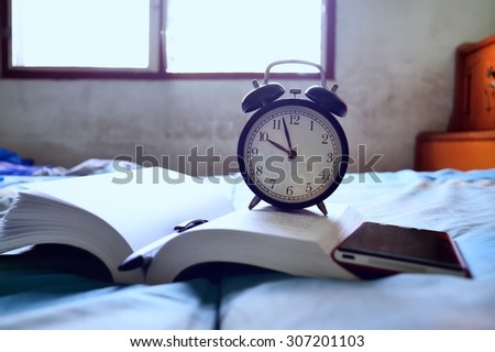Alarm clock on book at home / Alarm clock