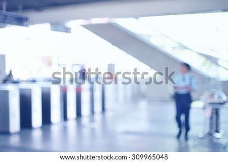 Blurred of Ticket Checker with security guard at train station