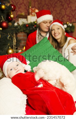 Happy family on Christmas and New Year. Father Mother and baby in Christmas designed home.  Santa Close, Baby dwarf and white princess
