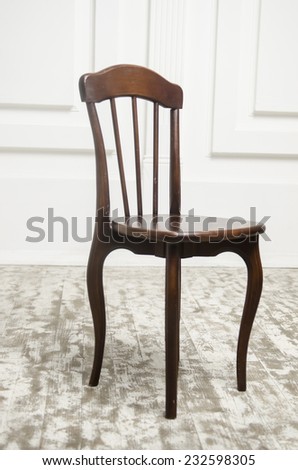natural dark wooden chair isolated on white wooden floor.